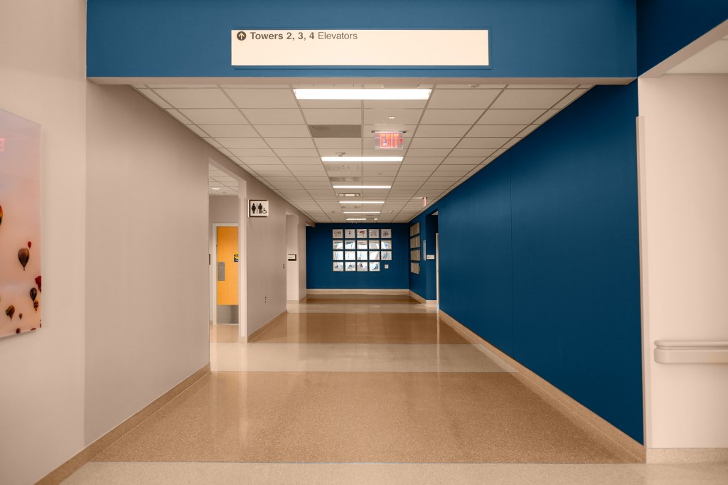 Professional interior photography of hospital corridor highlighting clean architectural lines and functional design.